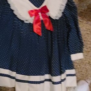 beautiful blue polka dotted dress with red bowl
